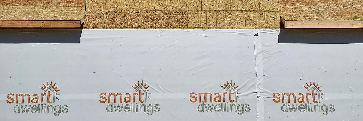 custom house wrap on new construction with brand logo for Smart Dwellings 2023